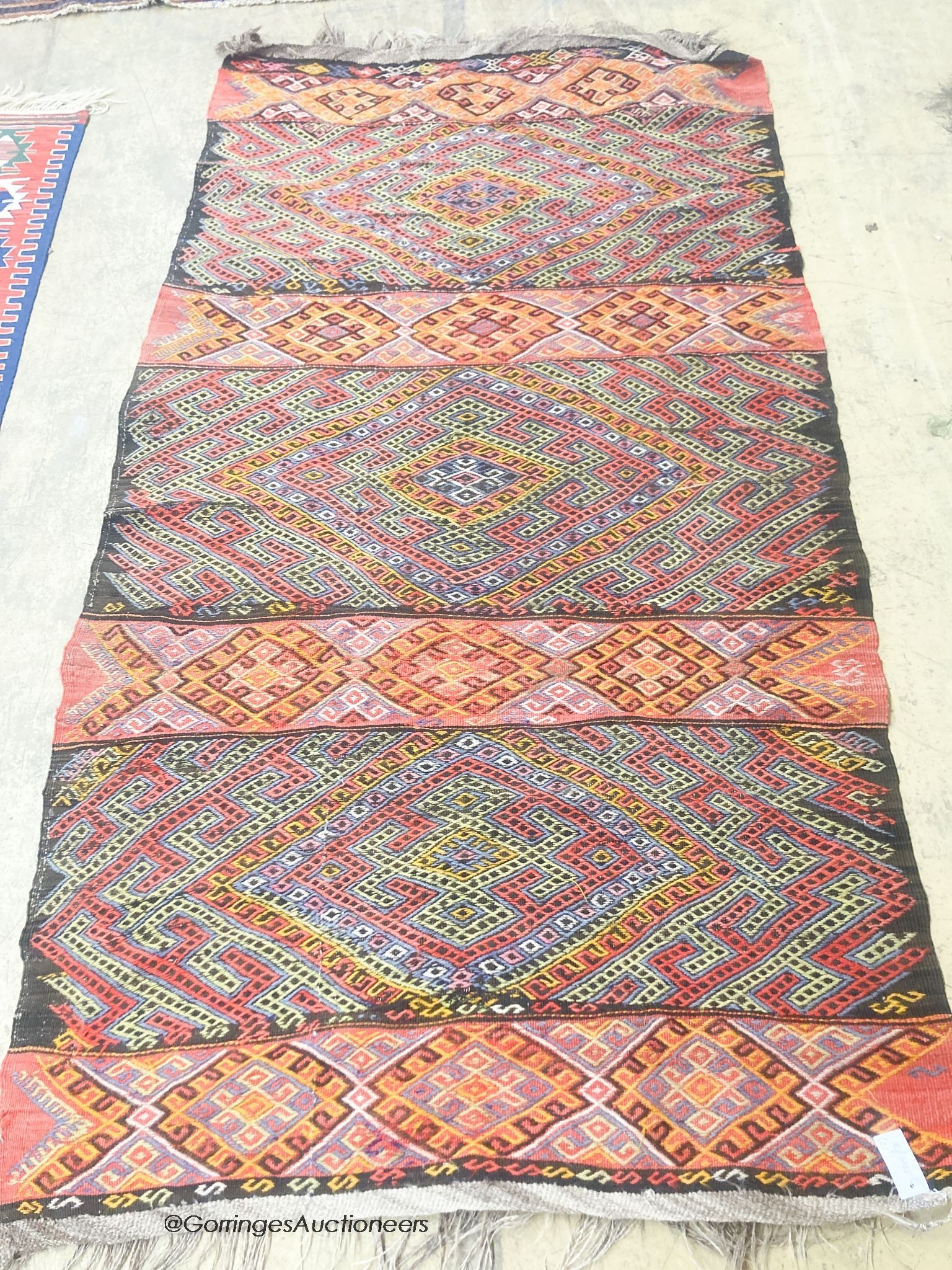 A polychrome flatweave geometric rug, 240 x 124cm together with a smaller Bokhara rug